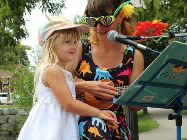 Three-year-old Melody Fowler joins her mom Whitney Fowler, also known as the Singing Hen, on the stage Sunday, July 31 at the Simcoe Heritage Friendship Festival. MICHELLE RUBY