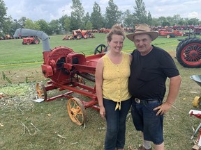 Erica and Jake Tapp of Lowbanks are shown Monday, Aug.  1 with a Massey Harris 'Blizzard' silage cutter that was built in 1911. The couple attends the annual Walpole Antique Farm Machinery Association's Heritage Day Weekend every year.  VINCENT BALL