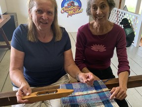 Kathy Evans and Karen Van Eyk use a loom on Monday, Aug.  1 that was donated to the Old Jarvis Train Station by the Hugh Clark Collection in Hagersville back in 2017. The loom was made in the 1800s and is part of the station's permanent collection, which includes photographs and artifacts from the days when the railway was a vital link to the rest of Canada for the community.  VINCENT BALL
