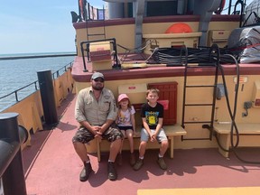 Colter, from left, Jaxlyn and Landon Chapman take at break during a tour of the Theodore Too in Port Dover on Wednesday.  The iconic tugboat is in Port Dover from Aug.  3-6.  ALEX HUNT