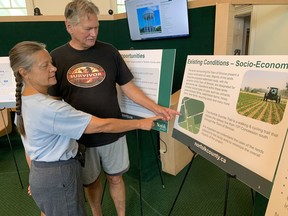 Diane and Dennis Sovereign,of Simcoe, take a close look at plans for the Simcoe-Townsend water supply system project at a public information centre held Thursday, Aug. 4  in the Norfolk County Council chambers. The session attracted close to 20 people and is the first of two public meetings.