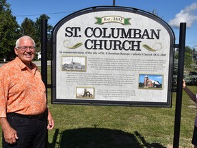 Tom Melady (left) and Nancy Kane stand beside a new sign marking the site of the now torn down St. Columban Roman Catholic Church in the village. The sign will be officially dedicated during a brief ceremony on Sunday, Aug. 7 at 2 p.m. ANDY BADER/MITCHELL ADVOCATE