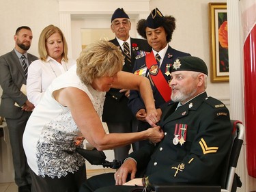 AlgomaÑManitoulinÑKapuskasing MP Carol Hughes presents veteran Bill Kerr with the War Pensioners of Canada Meritorious Service medal at a memorial service honouring Canadian soldiers who served in the Afghanistan conflict at the Cooperative Funeral Home in Sudbury, Ont. on Tuesday August 9, 2022. John Lappa/Sudbury Star/Postmedia Network