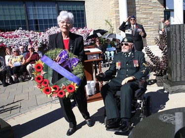 Claudette Roberge, mother of WO Gaetan Roberge, is accompanied by veteran Bill Kerr as she lays a wreath at a memorial wall of fallen soldiers at a memorial service honouring Canadian soldiers who served in the Afghanistan conflict at the Cooperative Funeral Home in Sudbury, Ont. on Tuesday August 9, 2022. John Lappa/Sudbury Star/Postmedia Network
