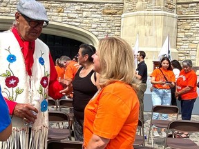 Eugene Arcand, a residential school survivor, talks to Sudbury MP Viviane Lapointe in Ottawa on Monday. Supplied