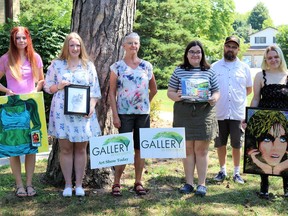 Four recipients of this year's Gallery in the Grove Senior High School scholarships have received $1,000 to go towards their post-secondary education in the arts.  From left are Baillie Loucks, Tanis DeGurse, Gallery in the Grove's Gwen Moore, Olivia Bourne, Northern Collegiate art teacher/juror Trevor Jamieson and Ava Martens.  Carl Hnatyshyn/Sarnia This Week