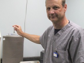 Jozef Nycz, lead nuclear medicine technologist at Timmins and District Hospital, demonstrates the use of a dose calibrator in the hospital's Diagnostic Imaging Department. He is seen here placing a syringe in the unit's chamber while the attached device would then provide a read-out.
RON GRECH/The Daily Press