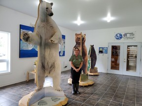 Gail Palmer, one of the new bear keepers, looks quite small standing beside an actually size replica  of a polar bear, a grizzly and  a brown bear. Palmer invites you to check out the exhibit at the Polar Bear Habitat which is between the gift shop and the snowmobile museum.