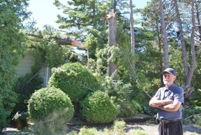 Bob Russell stands outside his home on the north end of Sauble Beach near the Sauble River, Thursday, Sept. 1, 2022, the day after a suspected tornado ripped through the area Wednesday afternoon, snapping trees and damaging houses.