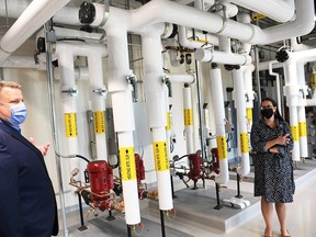 Aaron Ryan, vice president of performance and chief financial officer for the Chatham-Kent Health Alliance, left, and Terra Kitzul Arens, project manager of facilities planning, give a tour of the mechanical room at the Wallaceburg hospital's new power plant Sept. 1, 2022. (Tom Morrison/Postmedia Network)