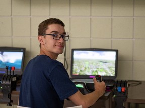 Flight Sergeant Addison Champagne of 664 Cold Lake, Royal Canadian Air Cadet Squadron, in Cold Lake, at the controls of a flight simulator at Cold Lake Cadet Training Centre on August 16, 2022.