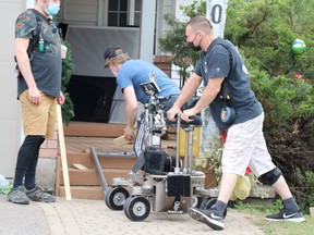 Crew work on the set of A Christmas Letter in May 2021. BRIAN KELLY