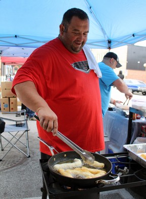 Franco Gabriele of the Sarnia Street Cruisers deep fries cinnamon sticks during the Weekend Walkabout event Sunday in downtown Sarnia.  Terry Bridge/Sarnia Observer/Postmedia Network