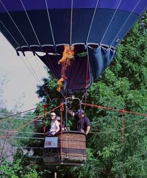 Elizabeth Barnard, left, mom April and hot-air balloon pilot Jimmy Osmond float up in the air during the Sarnia Sting's fundraising golf tournament for Pathways Health Center for Children on Saturday at Huron Oaks Golf Course in Bright's Grove.  Terry Bridge/Sarnia Observer/Postmedia Network