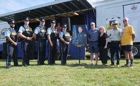 An official park dedication ceremony was held Saturday at Sgt.  Andrew Harnett Memorial Park in Hagersville.  Among those attending during the Summer's End Festival were from left Auxiliary OPP members Gurpreet Singh, Alex Blakeny, Tom Samac, Phil Toffolo and Chris Dennis, with Jason, Valerie and Chris Harnett, and Hagersville Lions Club member Albert Ribbink.