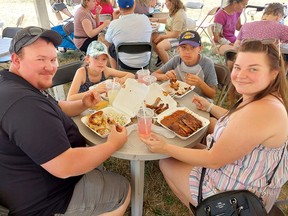 Mike Guyett, left, of Dealtown, is seen here enjoying some great food at Chatham-Kent Ribfest on in July with his daughter Addisyn, 9, son Keegan, 12, and wife Courtney. The event is one of several which will need to relocate in 2023 due to construction around Tecumseh Park. Ellwood Shreve/File photo