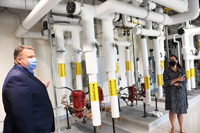 Aaron Ryan, vice president of performance and chief financial officer for the Chatham-Kent Health Alliance, left, and Terra Kitzul Arens, project manager of facilities planning, give a tour of the mechanical room at the Wallaceburg hospital's new power plant on Sept. 1 Tom Morrison/Chatham This Week