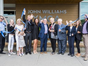 Members of the Williams family and local political leaders celebrate after cutting the ribbon officially naming the Quinte West YMCA in honour of former mayor John Williams on Wednesday. ALEX FILIPE