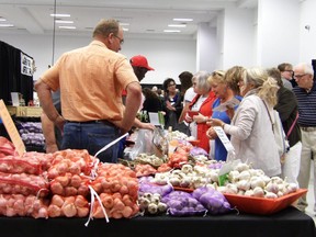 The Stratford Kiwanis Garlic Festival is returning to the Stratford Rotary Complex this weekend after a two-year hiatus. Pictured, 2019 festival goers peruse the offerings of a garlic vendor at the last Stratford Kiwanis Garlic Festival. (Submitted photo)
