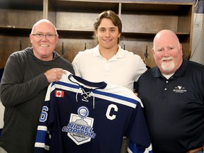 Sudbury Nickel Capitals U18 AAA forward Kohen Crane, centre, receives the captain's jersey from head coach Brian Dickinson, left, and assistant Clayton Bertrand at Gerry McCrory Countryside Sports Complex in Sudbury, Ontario on Thursday, September 1, 2022.