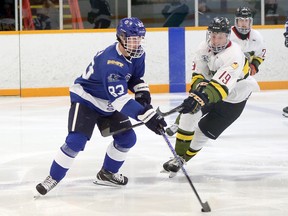 Greater Sudbury Cubs defenceman Graeme Siren (83) handles the puck while under pressure from Powassan Voodoos forward Rhys Smetham (19) during the Cubs' NOJHL season opener at Gerry McCrory Countryside Sports Complex in Sudbury, Ontario on Thursday, September 8, 2022.