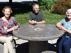 Garna Argenti, Robert Laidlaw Ondrovcik and Bonnie Verfaillie sit at a new picnic table in Veterans Tribute Park in Chatham which commemorates the Platinum Jubilee of Queen Elizabeth II Sept. 8, 2022. The IODE Kent Regiment chapter used a $5,000 grant from the federal government to install the table. (Tom Morrison/Postmedia Network)