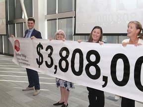 Cabinet members for the United Way of Kingston, Frontenac, Lennox and Addington, from left Jamie Pickers, Helen Mabberly, Constance Carriere-Prill and Krista Wells Pearce, unveil the 2022 campaign goal of $3.808 million at St. Lawrence College in Kingston on Friday. Also at the unveiling are Leeann O’Mara and Pat Murphy.
