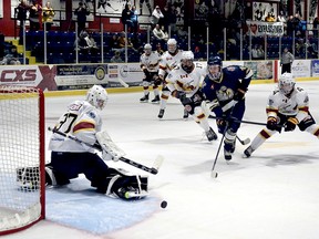 Timmins Rock goalie Jacob Brown makes one of his 29 saves, stopping a shot of the stick of Kirkland Lake Gold Miners forward William Neeld as teammates, from left, Hayden Rynard, Christophe Petit, Tenzin Nyman and Yenry Jibb, during Saturday night’s NOJHL contest at the Joe Mavrinac Community Complex. Brown, a 16 year old making his first NOJHL start, picked up the shutout as the Rock blanked the Gold Miners 2-0. NOJHL NETWORK