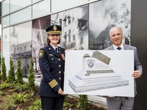 Belleville Fire Chief Monique Belair and Belleville Mayor Mitch Panciuk hold a digital rendering of the upcoming Belleville Firefighters Memorial monument to be installed by Campbell Monuments at the newly planted memorial gardens in front of Emergency Services Station 1 in Belleville, Ontario. ALEX FILIPE