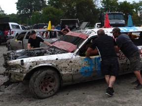 Jonathan Chretien's crew tries to nudge his limo into forward gear before the start of the open category during the Fireball Enduro at the Cornwall Motor Speedway on Sunday September 11, 2022 in Cornwall, Ont. Greg Peerenboom/Special to the Cornwall Standard-Freeholder/Postmedia Network