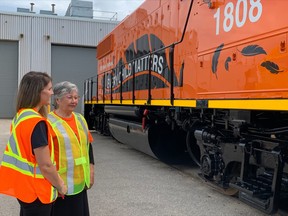 June Commanda, a residential school survivor talks to Kate Bondett, communication and issues management specialist at Ontario Northland Transportation Commission Monday during the unveiling of a newly painted locomotive.