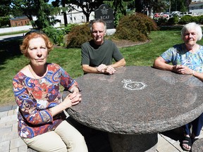 Garna Argenti, Robert Laidlaw Ondrovcik and Bonnie Verfaillie gather at a new picnic table commemorating the Platinum Jubilee of Queen Elizabeth II in Veterans Tribute Garden in Chatham on Sept. 8. The table was a project from the IODE Kent Regiment chapter using a federal government grant. (Tom Morrison/Chatham This Week)