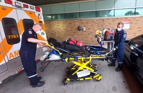 Matt Laverty, an advanced care paramedic, and Andrew Whittemore, an intensive care paramedic, prepare to pick up a patient from Windsor to be transferred to London Hospital to receive a higher standard of treatment for a heart condition .  They are part of the team working from the now permanent Critical Care Land Ambulance Base in Chatham-Kent.  Ellwood Shreve/Postmedia