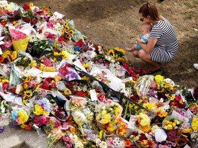 Floral tributes are left by people in St James?s Park, in London, Britain, September 12, 2022. REUTERS/Peter Cziborra