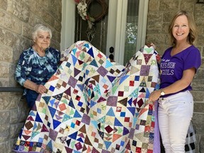 Days for Girls leader Alice Burgsma, right, presents Ruth Alton with a quilt created by Days for Girls volunteer Suzanne Irwin.  Ruth Alton accepted the quilt on behalf of the Trinity UCW, who recently won the quilt as part of a Days for Girls fundraising campaign. Submitted photo.