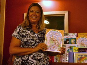 Former teacher and librarian Sue Palmer, who grew up in Stratford, has penned her first children's book, Just Ben Goes to the Forest. Pictured, Palmer shows off her book in the children's section at Fanfare Books in Stratford where it is being sold. (Galen Simmons/The Beacon Herald)
