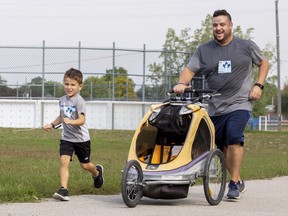 Jacob Kramer and his five year old son Jeffrey near the finish line of the 2022 Terry Fox Run in Brantford on Sunday.