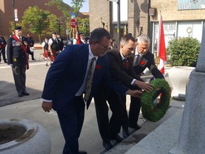 Chatham-Kent Mayor Darrin Canniff, left, Chatham-Kent-Leamington MPP Trevor Jones and MP Dave Epp lay a wreath during Monday's ceremony honouring Queen Elizabeth II at the downtown Chatham cenotaph. (Trevor Terfloth/The Daily News)