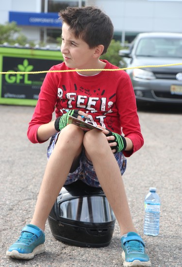 Atley Cripps, 9, watches the action at Lake Superior Soap Box Derby at Elim Pentecostal in Sault Ste. Marie, Ont., on Saturday, Sept. 17, 2022. (BRIAN KELLY/THE SAULT STAR/POSTMEDIA NETWORK)