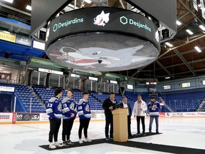 Sudbury Wolves owner and SWSE CEO Dario Zulich, centre, gives a toast while unveiling a new video board for season ticket holders and local media, alongside Wolves players Kocha Delic, Joe Ranger and David Goyette, Desjardins business development manager Gabriel Godin, Media Resources account executive Tim Monk and PA announcer JP St. Onge., at Sudbury Community Arena in Sudbury, Ontario on Friday, September 16, 2022.