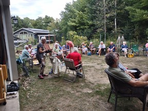 New and returning Huron Fringe Field Naturalists club members gather at the home of Christine Roberts for a corn roast and potluck dinner Sept. 10. Photo by Christine Roberts.