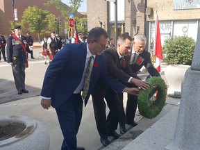 Chatham-Kent Mayor Darrin Canniff (left), Chatham-Kent-Leamington MPP Trevor Jones and MP Dave Epp placed a wreath during Monday's ceremony honouring Queen Elizabeth II at the downtown Chatham cenotaph. Trevor Terfloth/Postmedia