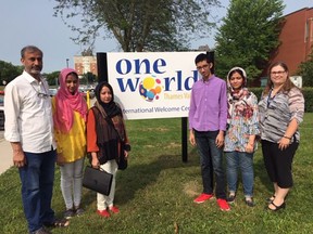 Newcomers to London from Pakistan Hood Ahmed, left, and his wife Nosheen, flank daughter Misha, 14, while son Hizkeel, 18, and daughter Immama, 17, stand with Sarah Leeming, who oversees international education for the Thames Valley District School Board at the board’s welcoming centre, One World, in 2019. File photo/Postmedia
