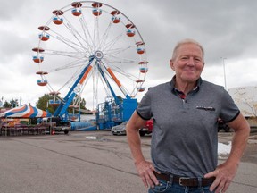 Martin Ritsma, chair of Stratford’s annual fall fair, is looking forward to the full-scale return of the event for first time since 2019. Dark clouds hovered above the ferris wheel at the Stratford Rotary Complex on Thursday, but Environment Canada expects those to clear by Friday. There is a 40 per cent chance of rain on Saturday, and a 70 per cent chance of rain on Sunday. (Chris Montanini/Stratford Beacon Herald)