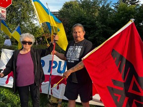 Irene Tomaszewski and Daryle Evan Kent protesting outside the Russian Embassy in Ottawa this month, with a Ukrainian flag and a Thunderbird flag.