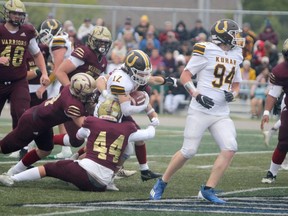 Korah Colts running back Jesse Burella (#12) rushes for positive yards against the Huron Heights Warriors defence during high-school football exhibition action at Superior Heights on Saturday night. Burella rushed for 153 yards on 20 carries as the Colts dropped a 14-13 decision to the No. 1 ranked Warriors.