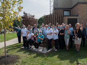 Health-care workers celebrate a relaxing addition to the landscape at St. Marys Memorial Hospital. One Bench One Tree, an Ontario-based volunteer group working to install one bench and plant one tree at every hospital in the country, recently announced four projects in Huron and Perth counties. Chris Montanini/Postmedia
