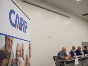 A banner for the Canadian Association of Retired Persons (CARP) is seen beside the region's mayors from Quinte West, Belleville, Prince Edward County and Brighton during their affordable housing panel held in Belleville, Ontario. ALEX FILIPE