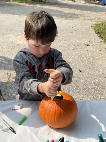 Huxley Phillips, 4, of Auburn decorates a pumpkin at the Lucknow Fall Fair on Sept. 17. Photo by Kelly Kenny/Lucknow Sentinel.