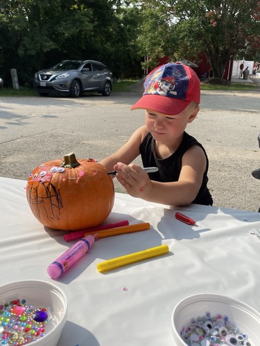 Three-year-old Cooper Oudshoorn of Auburn decorates a pumpkin during the Lucknow Fall Fair on Sept. 17. Photo by Kelly Kenny/Lucknow Sentinel.